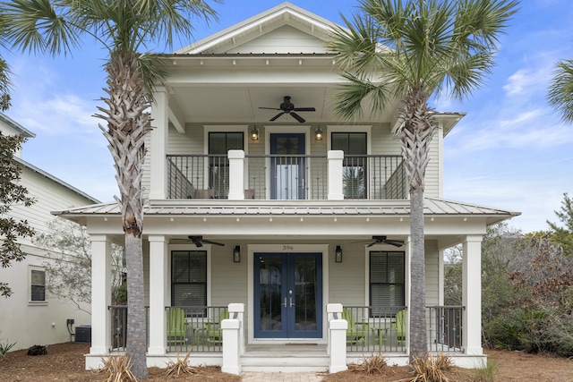 view of front of property with a balcony, ceiling fan, a porch, and french doors