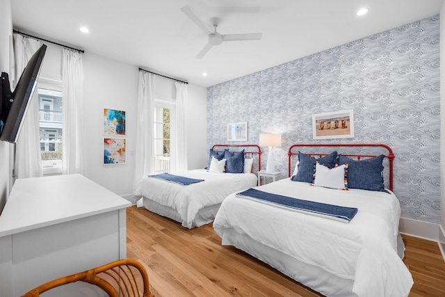 bedroom featuring baseboards, recessed lighting, light wood-type flooring, and wallpapered walls