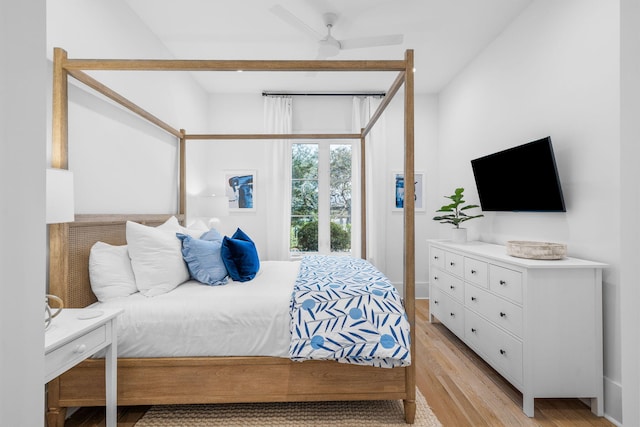 bedroom with light wood finished floors and beam ceiling