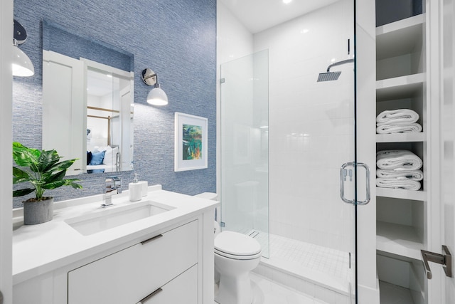 full bathroom with toilet, a shower stall, and vanity