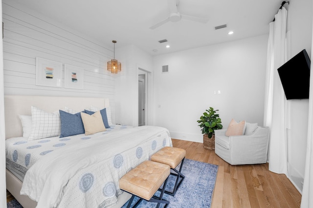 bedroom with a ceiling fan, visible vents, wood finished floors, and recessed lighting