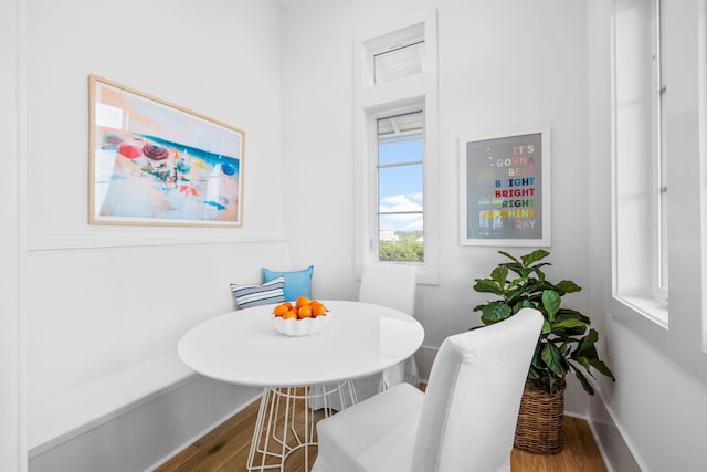 dining room featuring baseboards, breakfast area, and wood finished floors