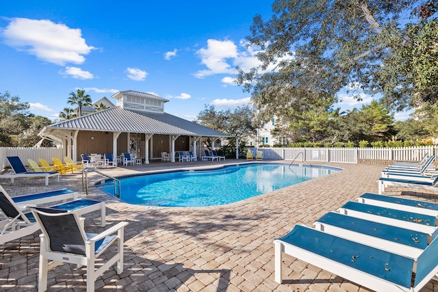 pool featuring a patio and fence