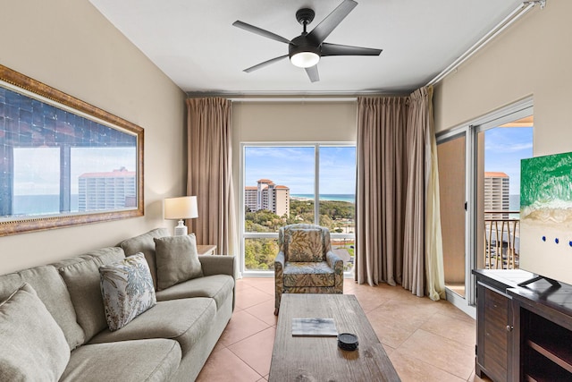 living area featuring ceiling fan and light tile patterned floors