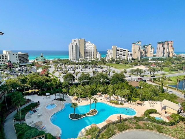 pool with a view of city, a patio area, and a water view