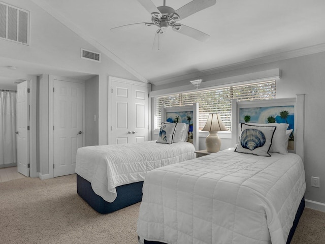 bedroom featuring vaulted ceiling, ornamental molding, carpet flooring, and visible vents