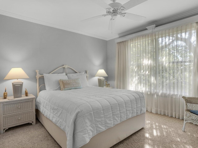 bedroom with ceiling fan, ornamental molding, and light colored carpet