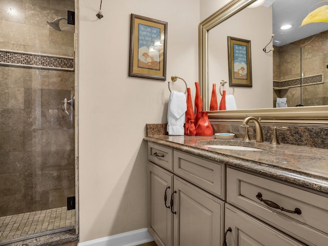 full bath with a shower stall, baseboards, and vanity