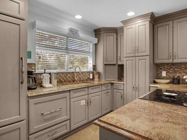 kitchen featuring decorative backsplash, a sink, black electric cooktop, and gray cabinetry