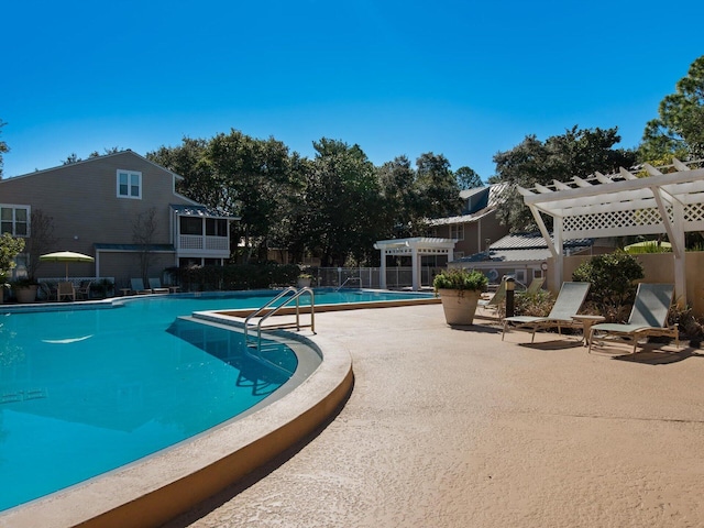 pool with a patio area, fence, and a pergola