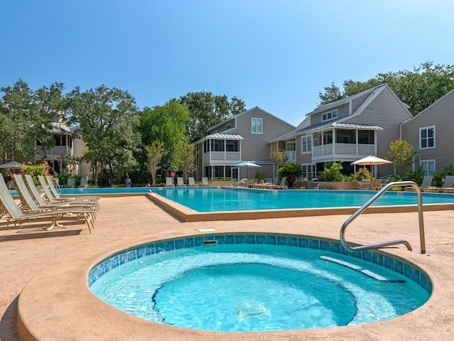 community pool featuring a community hot tub and a patio