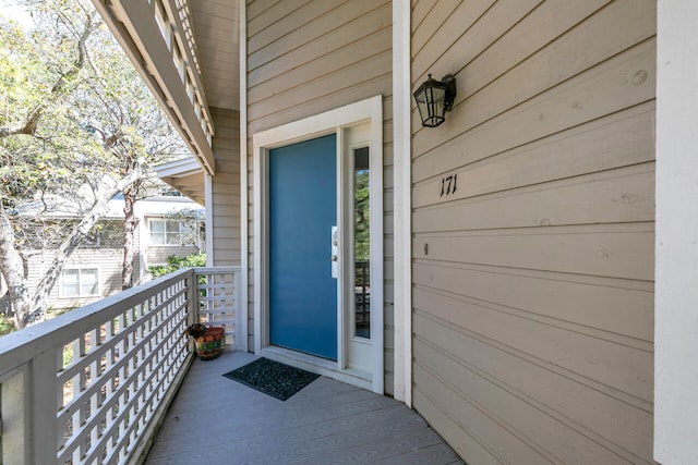 view of exterior entry with a balcony