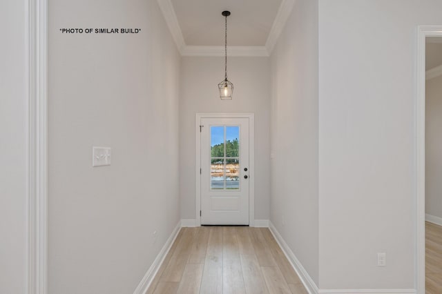 entryway featuring light wood-style floors, crown molding, and baseboards