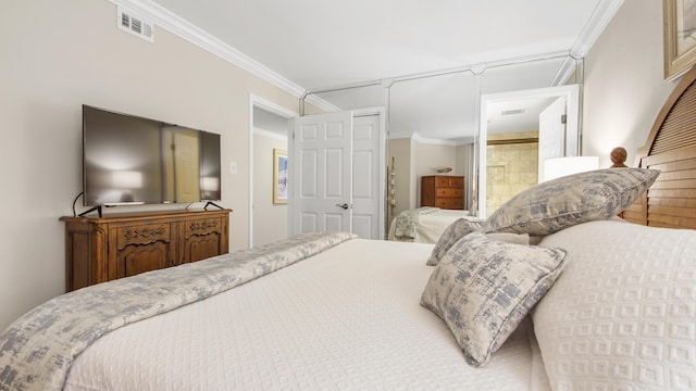 bedroom with visible vents, ensuite bath, and crown molding