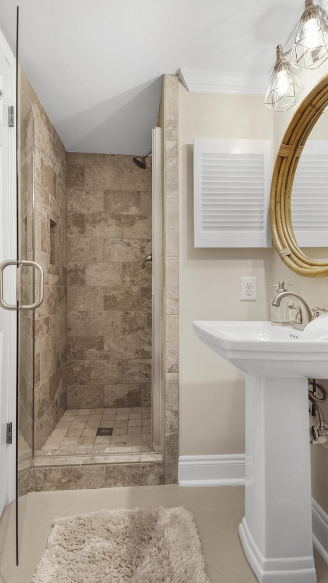 full bathroom featuring baseboards and a stall shower