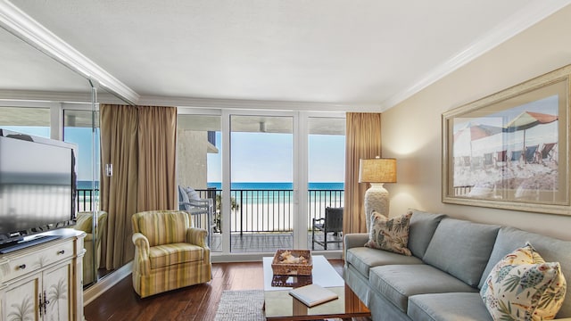 living area with dark wood-style floors, crown molding, a water view, and expansive windows