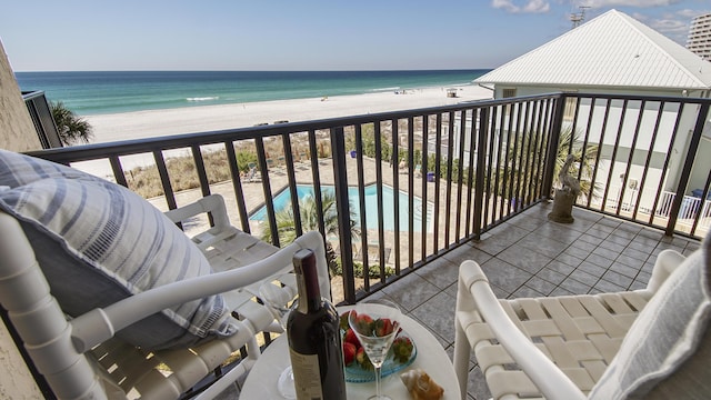 balcony with a water view and a beach view