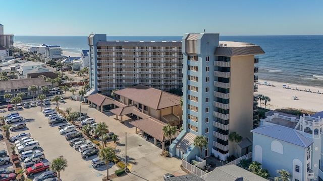 view of building exterior with a water view and uncovered parking