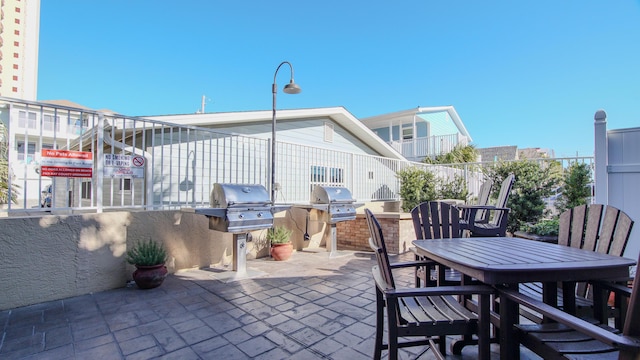 view of patio with outdoor dining area and area for grilling