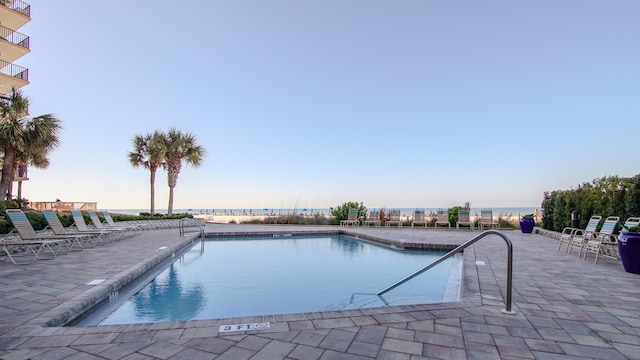 community pool with a patio area