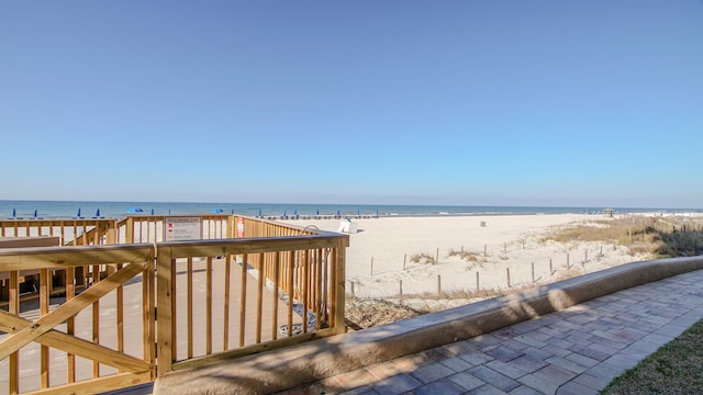 exterior space featuring a water view and a view of the beach