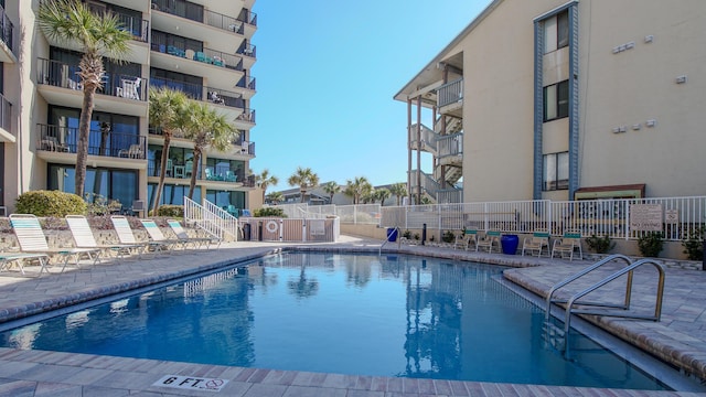 pool featuring a patio area and fence