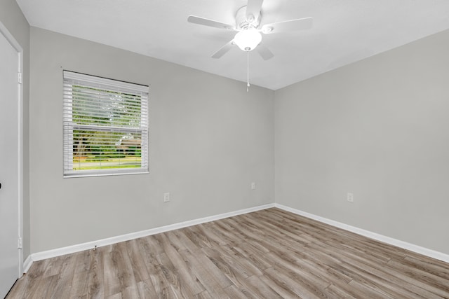 empty room featuring ceiling fan, wood finished floors, and baseboards