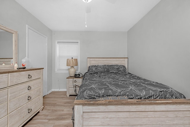 bedroom featuring light wood finished floors, ceiling fan, and baseboards