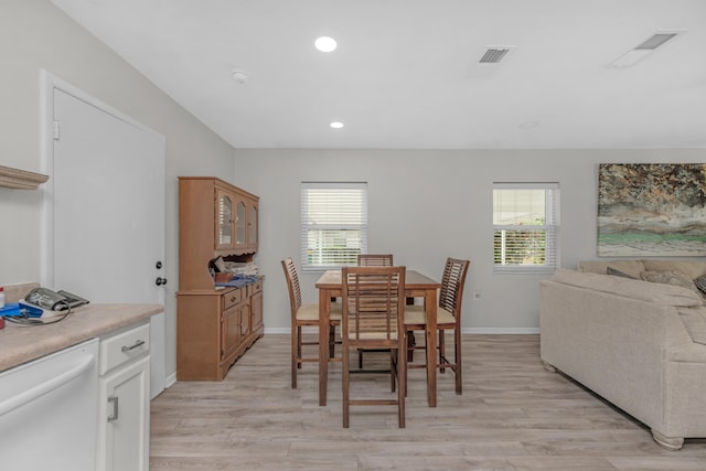 dining area with plenty of natural light, visible vents, and light wood-style floors