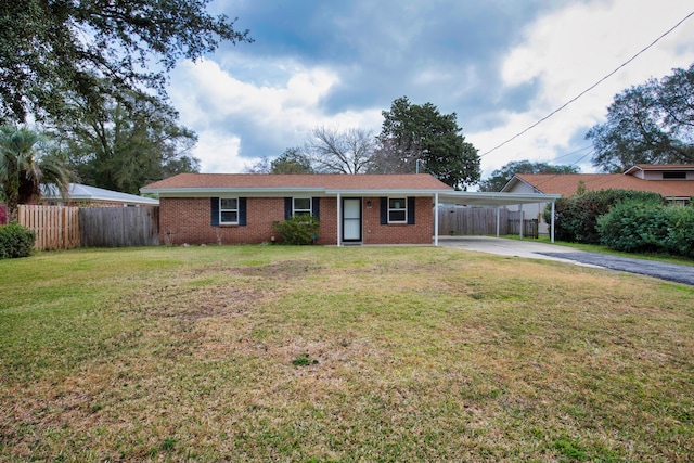 ranch-style house with driveway, an attached carport, fence, and brick siding