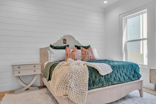 bedroom featuring light wood finished floors and multiple windows