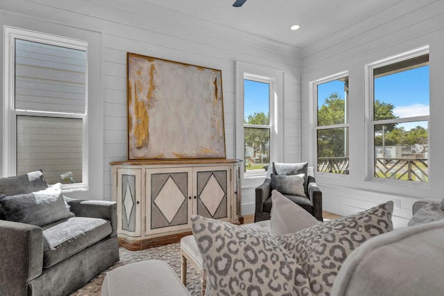 sitting room with wooden walls and recessed lighting