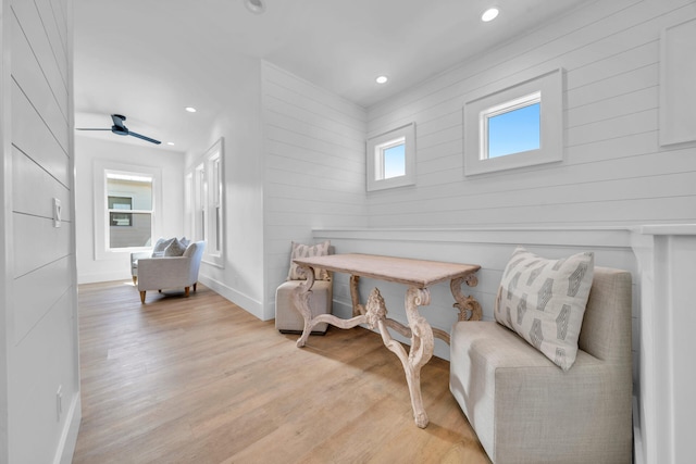 living area with light wood finished floors, baseboards, and recessed lighting