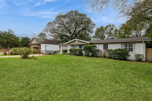 view of front of home featuring a garage, driveway, brick siding, and a front lawn