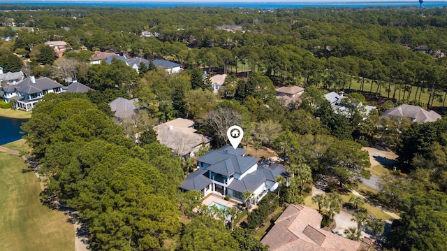 drone / aerial view with a water view, a forest view, and a residential view