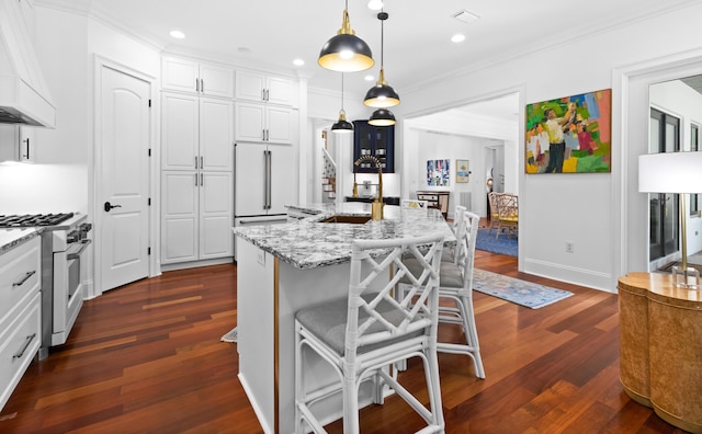 kitchen with visible vents, ornamental molding, custom range hood, white cabinets, and high end appliances