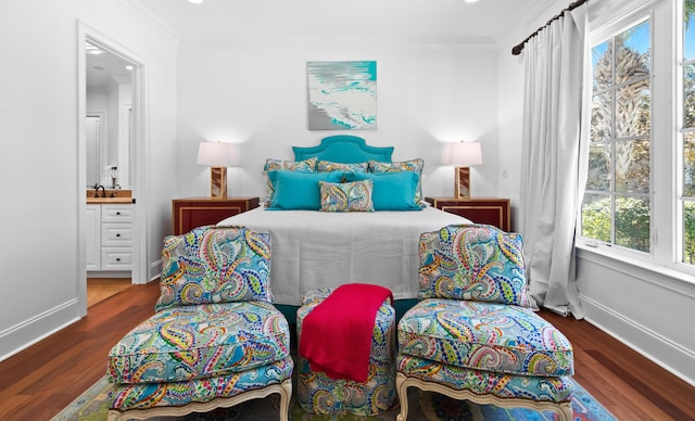 bedroom with wood finished floors, baseboards, and ornamental molding