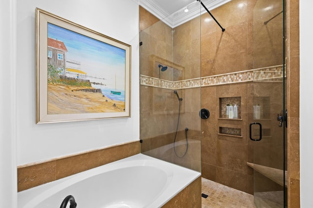 bathroom with a shower stall, a garden tub, and ornamental molding