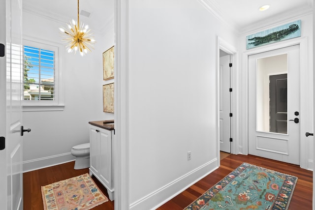 interior space featuring dark wood-style flooring, baseboards, and ornamental molding