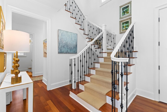 stairs with baseboards and wood finished floors