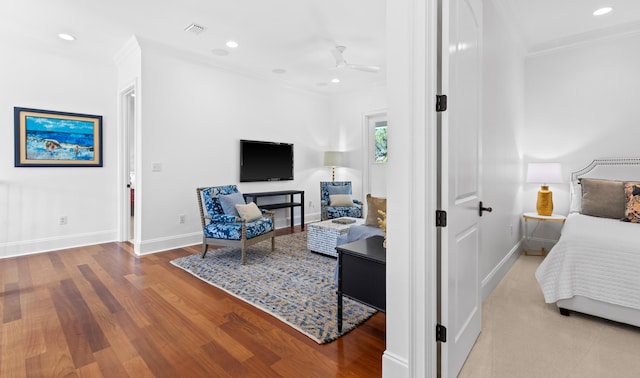 bedroom featuring visible vents, ornamental molding, wood finished floors, recessed lighting, and baseboards