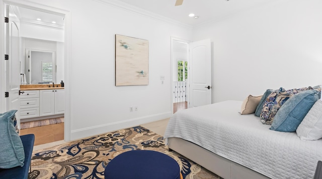 bedroom with crown molding, multiple windows, baseboards, and ensuite bathroom