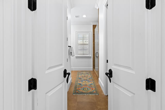 doorway featuring recessed lighting, visible vents, baseboards, and crown molding