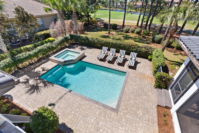 view of swimming pool with a patio and a pool with connected hot tub