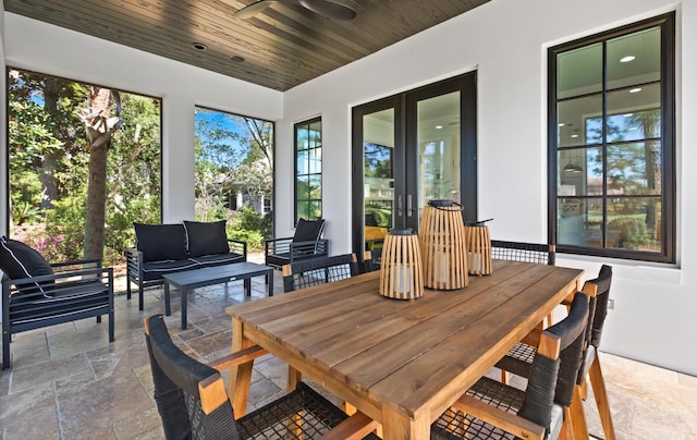 sunroom / solarium with french doors, wood ceiling, and ceiling fan