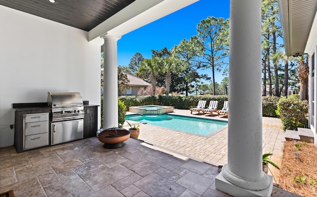 exterior space with exterior kitchen, area for grilling, and a pool with connected hot tub