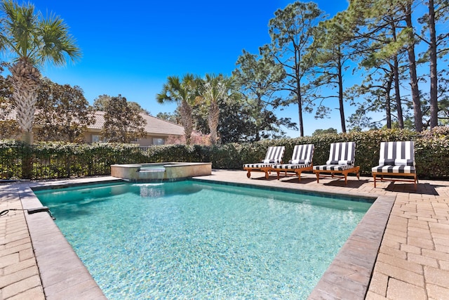 view of pool with a patio and a pool with connected hot tub