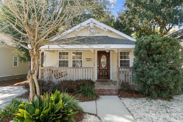 view of front of property featuring covered porch and a shingled roof