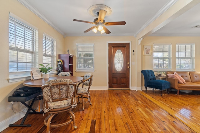 foyer featuring light wood-type flooring, a ceiling fan, baseboards, and crown molding