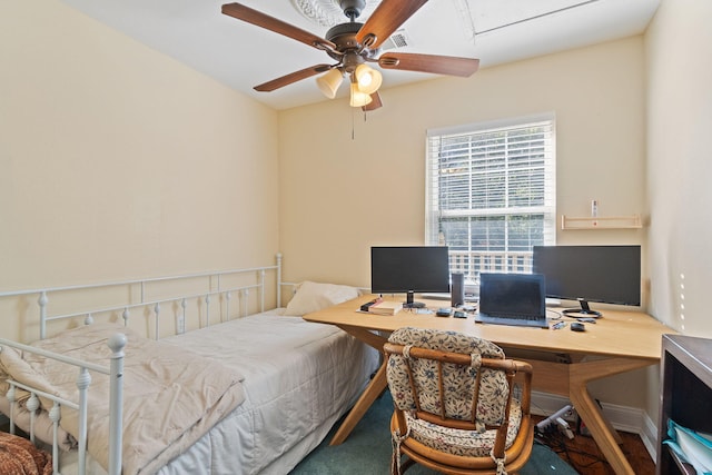 bedroom with attic access and ceiling fan